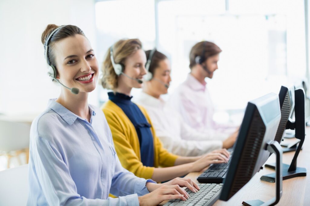 Smiling customer service agents wearing headsets