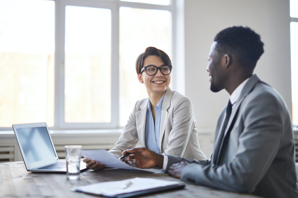 Business colleagues discussing documents at office desk