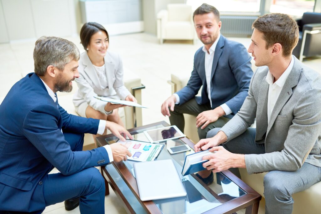 Business team meeting around table with devices