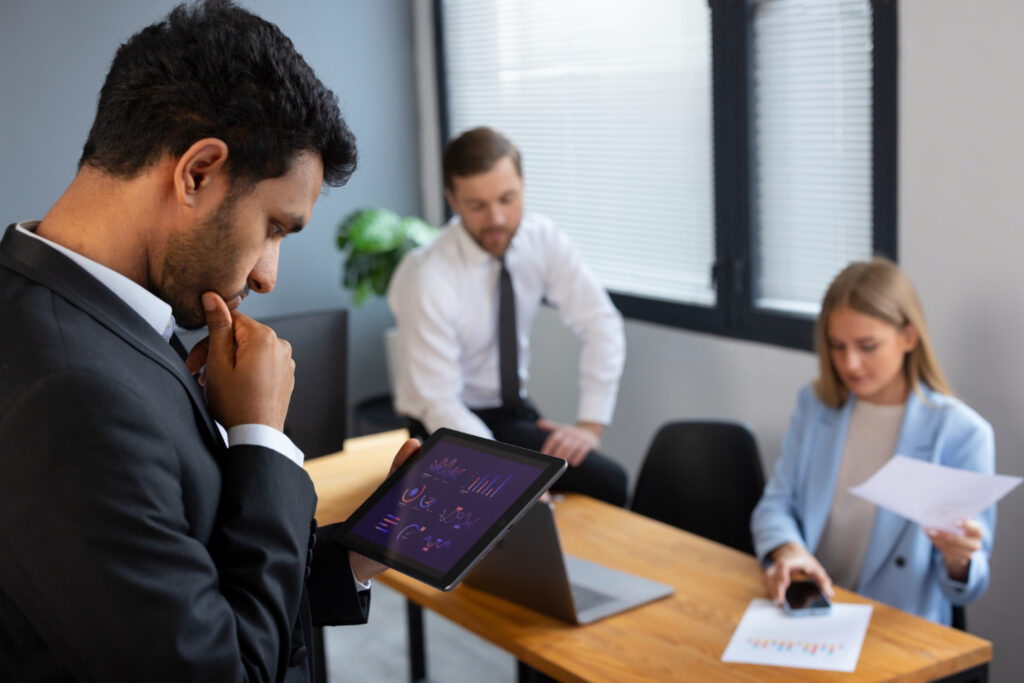 Business team reviewing tablet and documents
